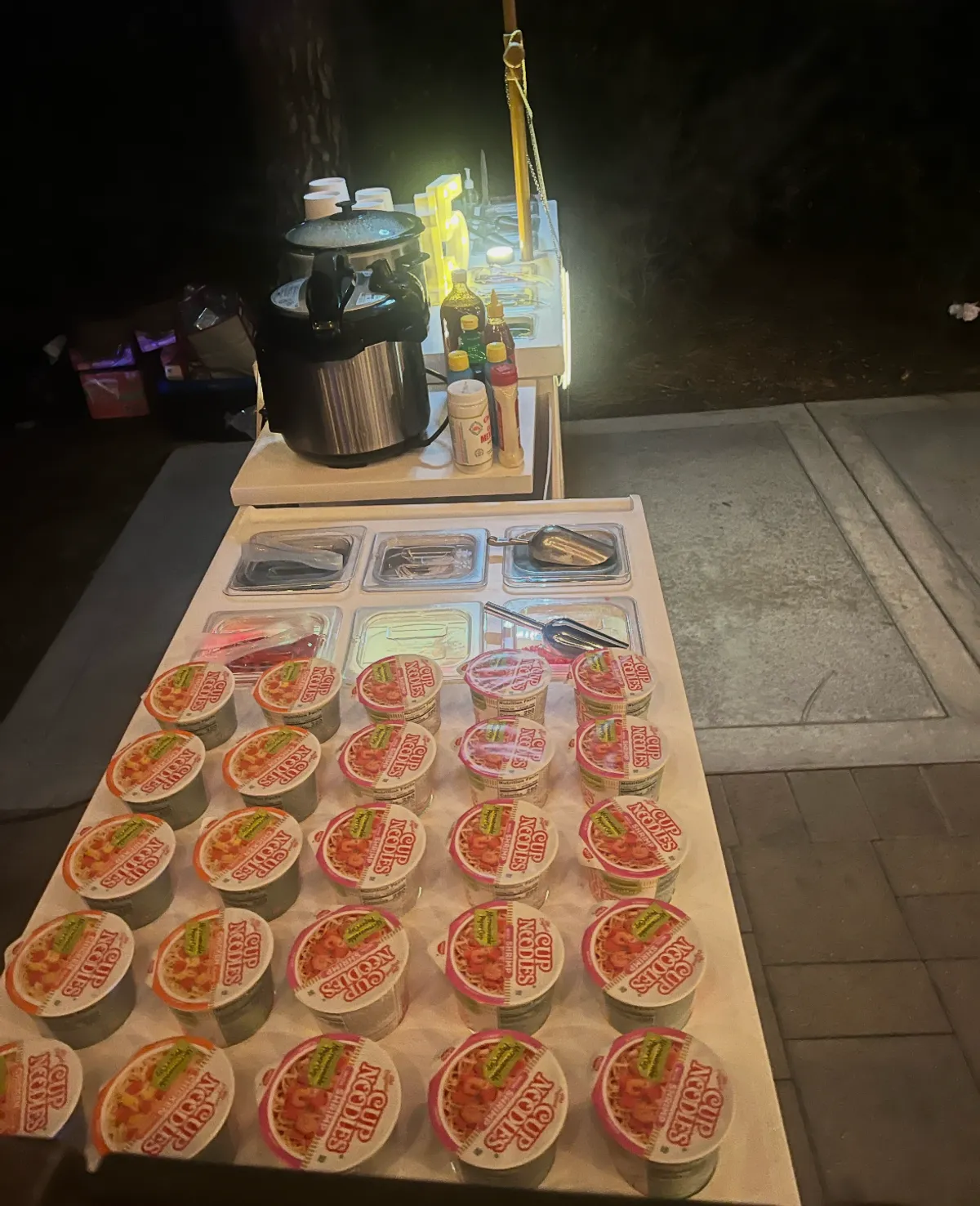 Rows of cup noodles arranged on the snack cart for a nighttime event